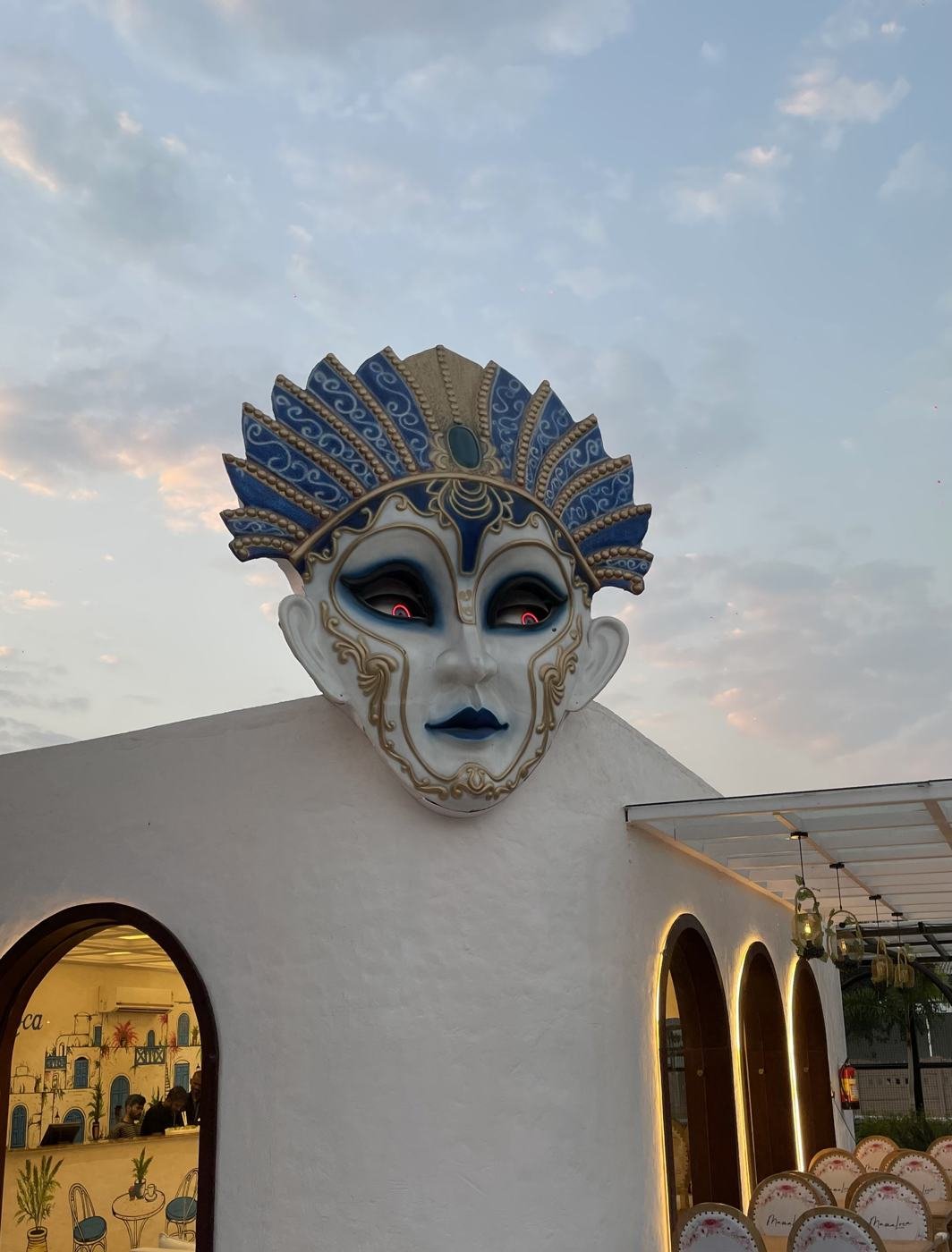 The mask above the arcade at Mama Loca 140